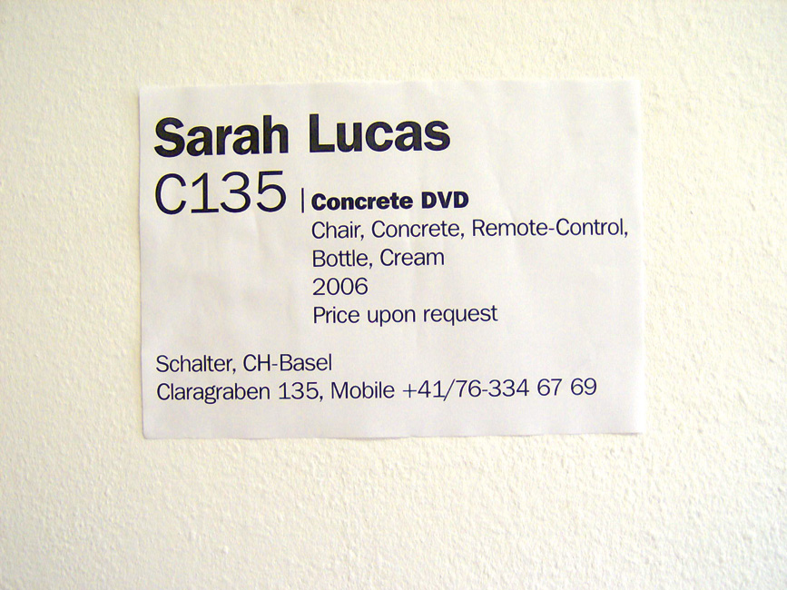 installation (Stuhl, Beton, DVD-Fernbedienung, Bierflasche, Rahm, Legende) detail